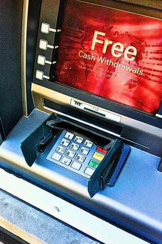 An ATM with a red screen showing keypad