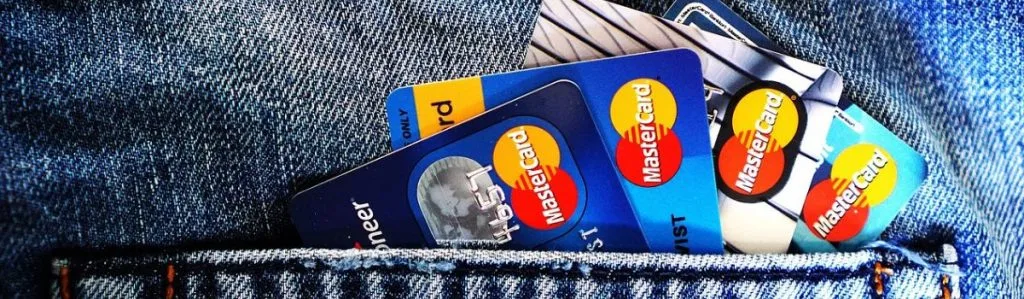 mastercard cards in a denim back pocket