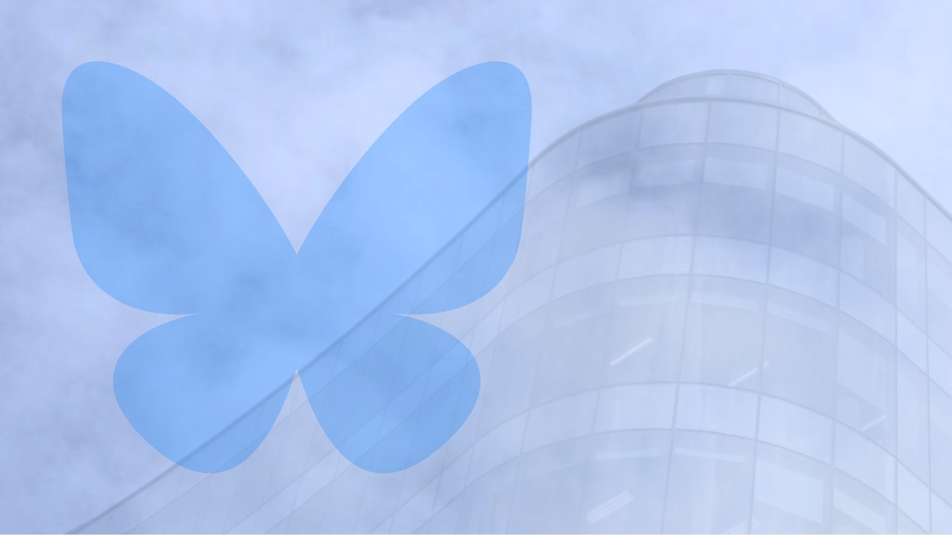 bluesky logo overlayed on blue sky and a building