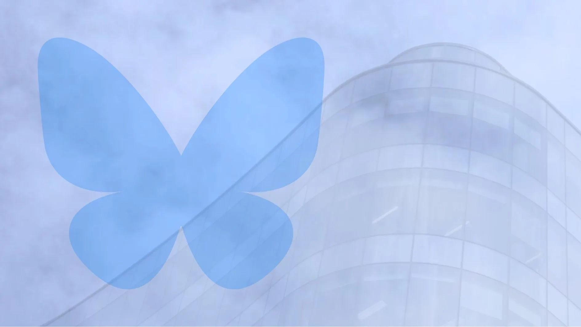 bluesky logo overlayed on blue sky and a building