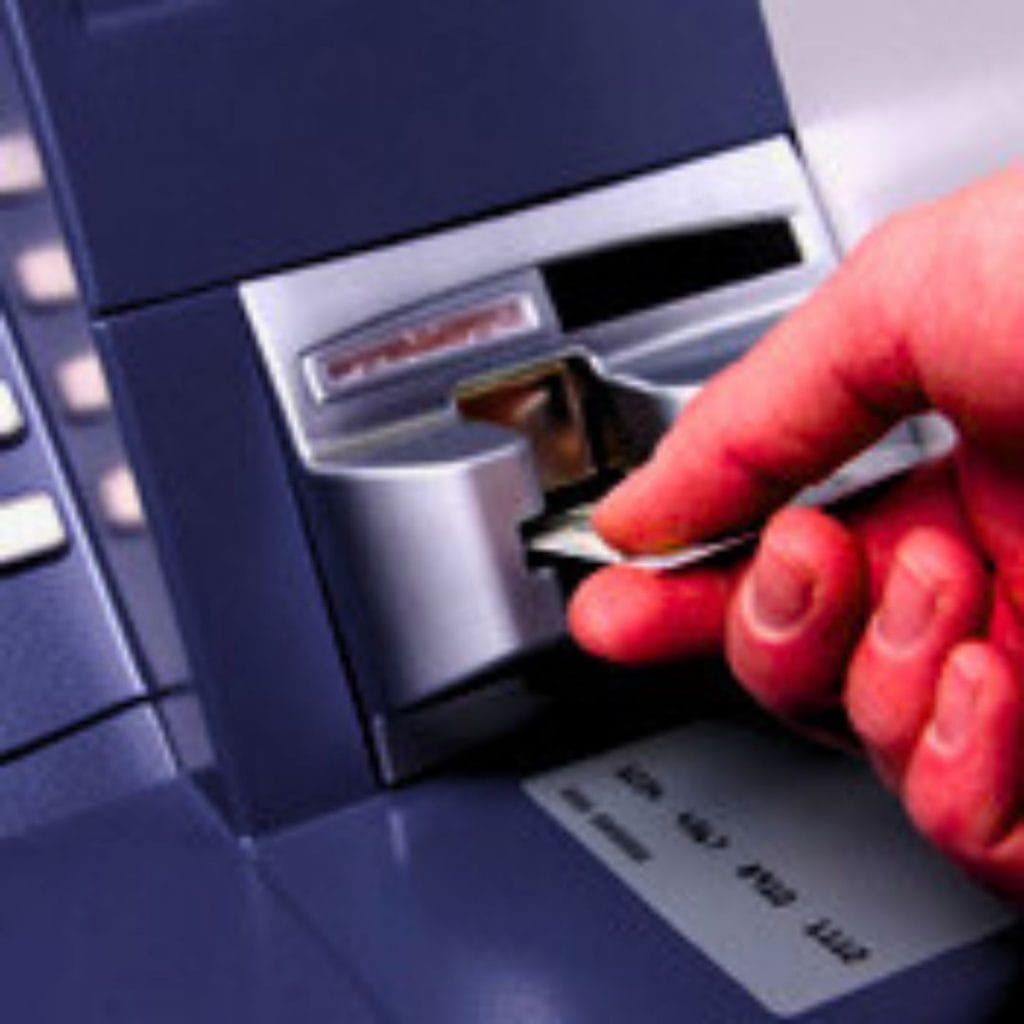 A picture of an ATM skimmer device attached to an ATM.