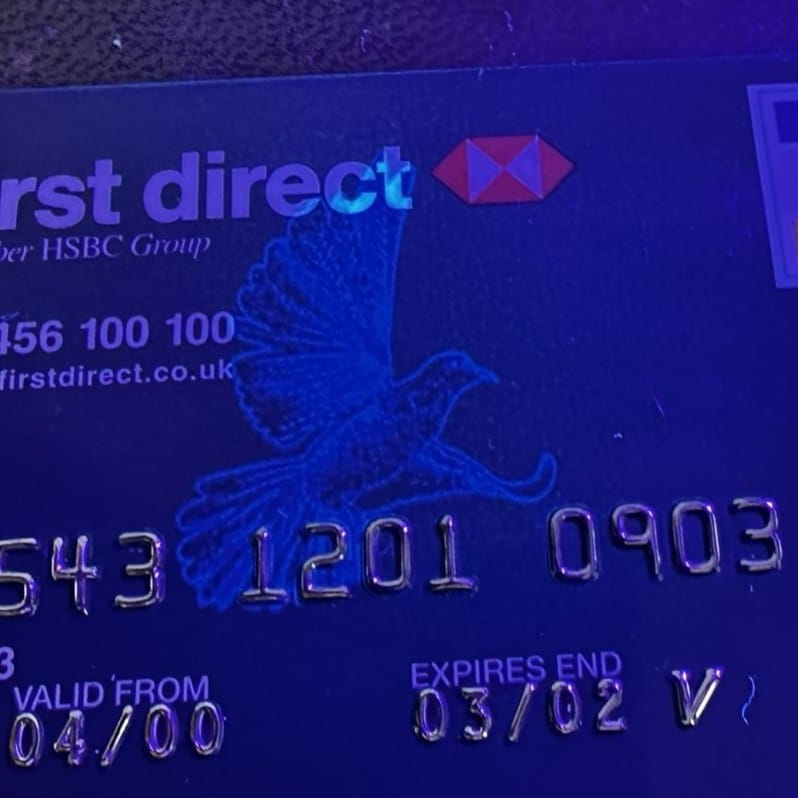 A visa card under UV light showing the dove.